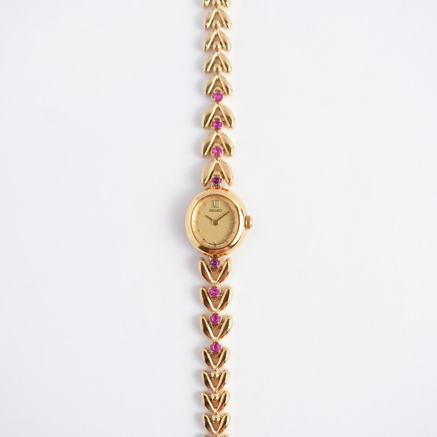 Seiko Ladies Ruby Bracelet 1E20-605A Gold Tone Watch